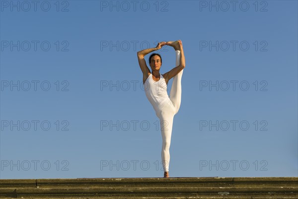 Young woman practising Hatha yoga