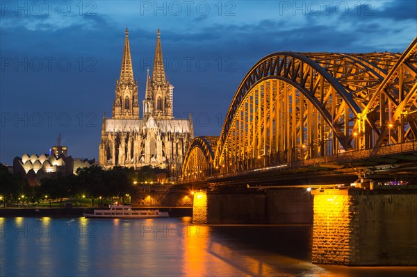 Cologne Cathedral with Hohenzollern Bridge and Cologne Philharmonic Hall at dusk