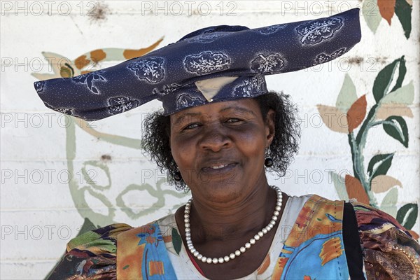 Local Herero woman wearing typical headdress and dress