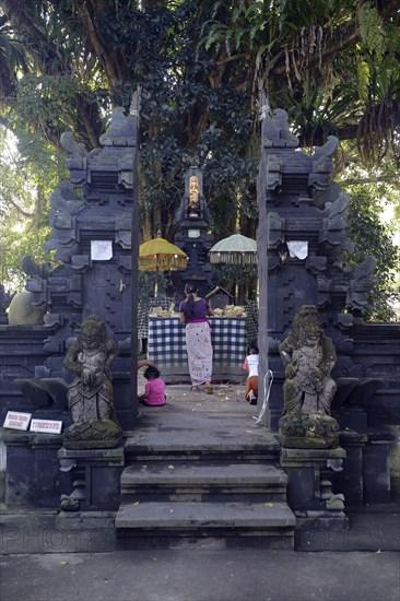 Believers making offerings in a small side temple