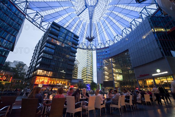 The illuminated dome and restaurants in the forum of the Sony Center