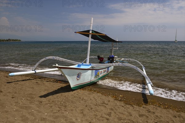 Traditional outrigger boat on the black lava beach