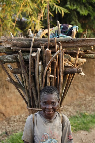 Old woman with firewood on her back