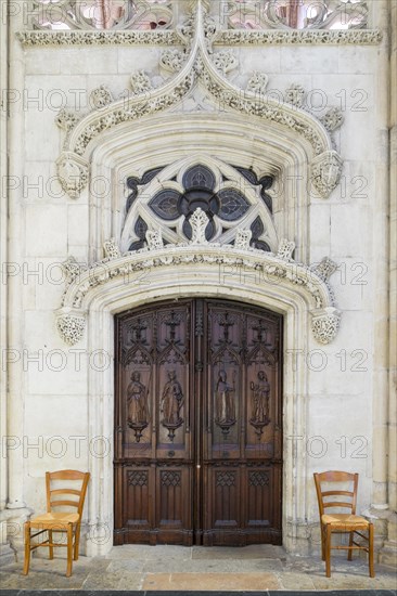 Ornate carved wooden doors and stone carvings inside of Cathedrale Saint-Gatien cathedral