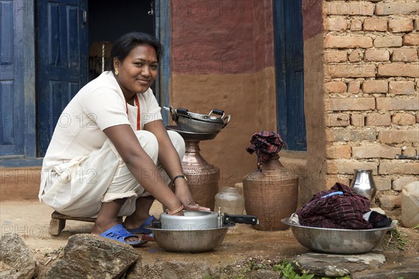 Nepalese woman doing the dishes
