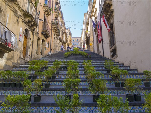 The Santa Maria del Monte staircase with ceramic tiles and potted plants