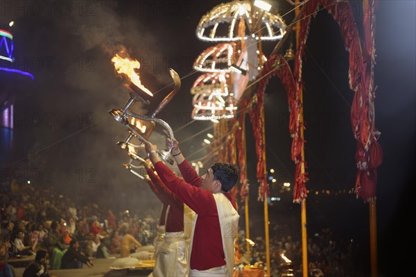 Priest celebrating the Aarti by offering incense