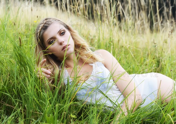 Young woman in lingerie posing outdoors