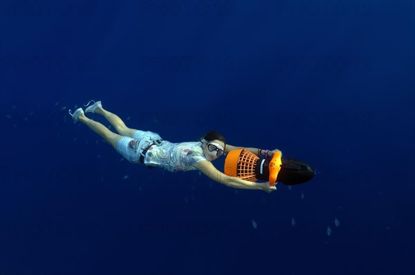 Freediver with an underwater scooter