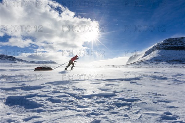 Ski tourers with Pulka in the snow