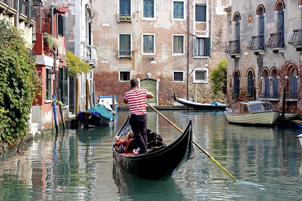 Gondola with gondolier using cell phone