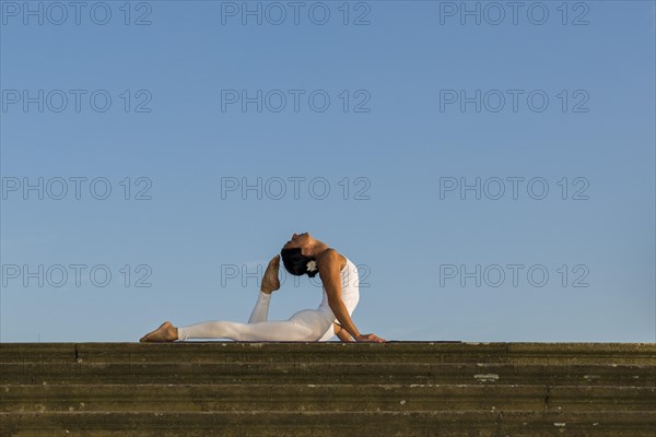 Young woman practising Hatha yoga