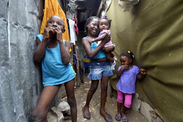 Four children in the entrance of a shack