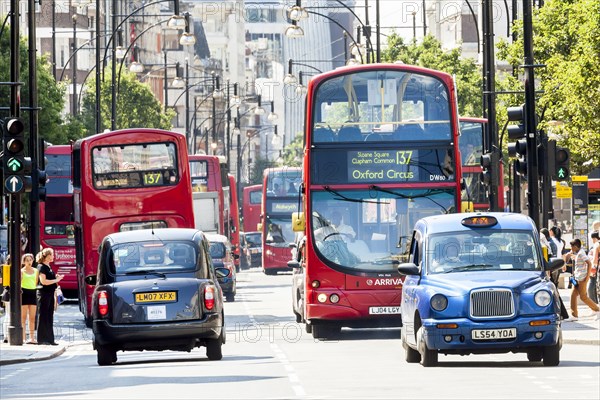 Double-decker buses and British taxis in Oxford Street