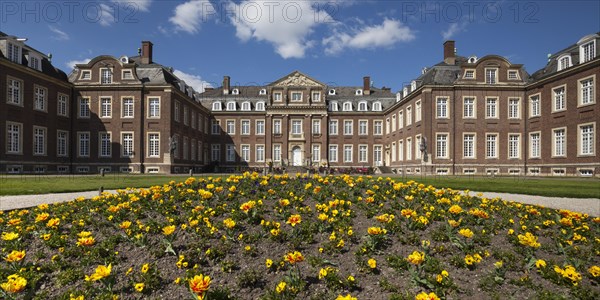 Blossoming tulips against moated castle