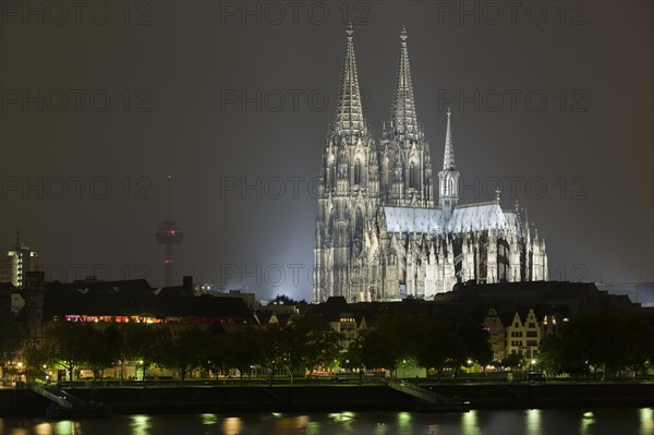 The Cologne Cathedral illuminated at night with Rhine