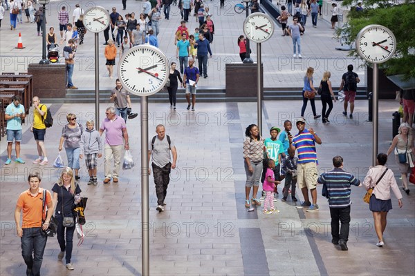 People in a square with clocks