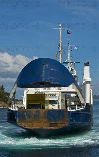 Ferry approaching the pier with an open bow section