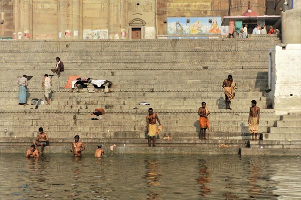Devotees in ritual ablutions on the banks of the Ganges