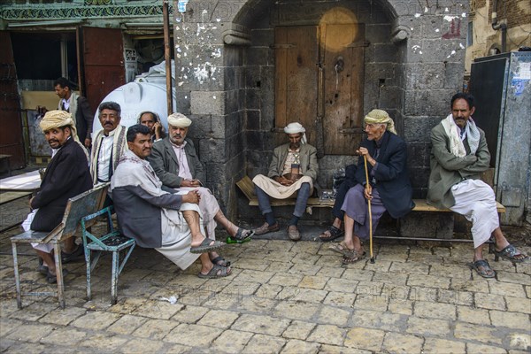 Men sitting in front of a house in the old city