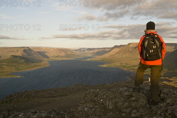 Woman looking across Dyrafjordur Fjord