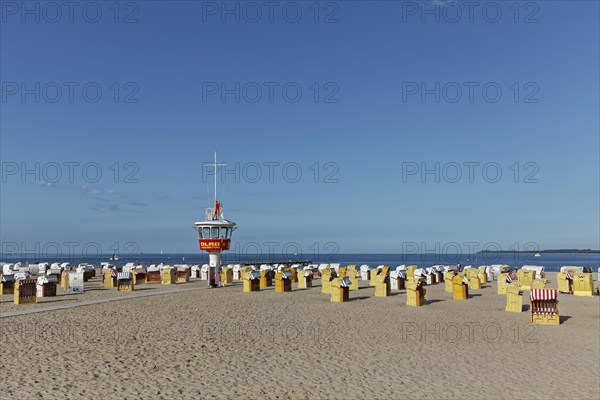 Empty sandy beach with beach chairs and DLRG-lifeguard tower