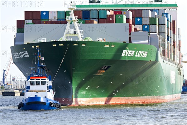 Containership Ever Lotus being towed by tug boat