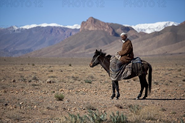 Nomad Berber riding a horse