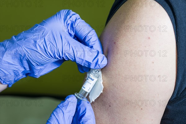 Injection of medicine into an arm