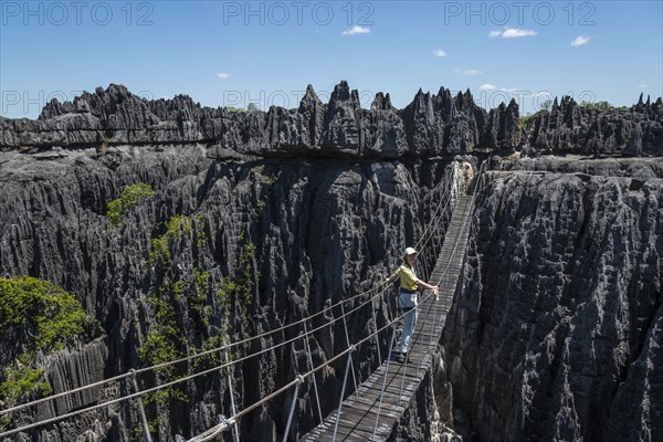 Woman on suspension bridge in the National Park Tsingy du Bemaraha