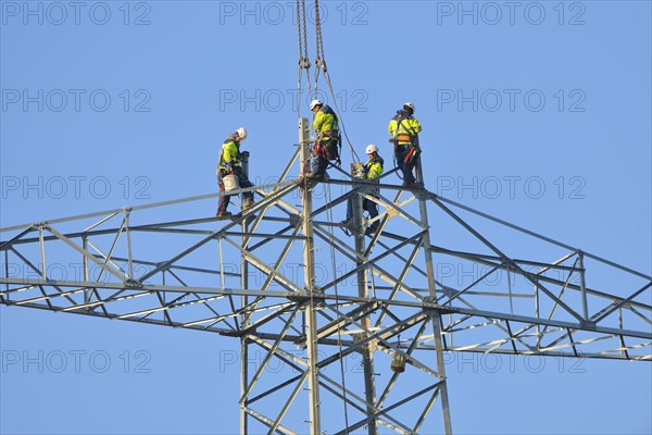 Overhead linemen working on a pylon