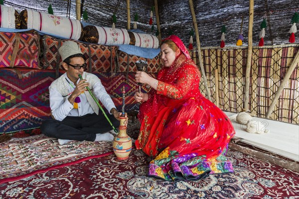 Qashqai couple smoking a water pipe in a tent