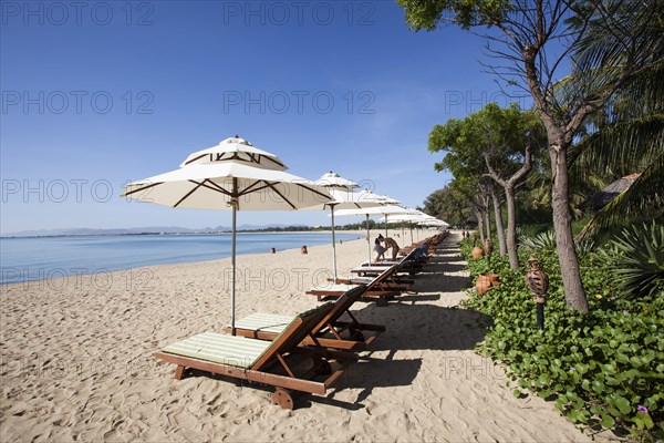 Beach with sun beds of the Saigon Ninh Chu Resort on the beach of Phan Rang