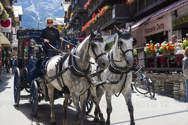 Horse-drawn carriage in Zermatter Bahnhofstrasse street