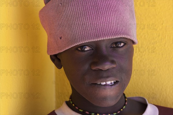 Namibian boy wearing a pink hat