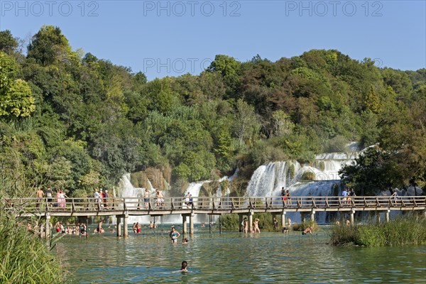 Bridge in front of a waterfall