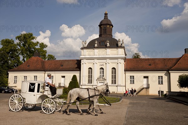 White carriage in front of the castle