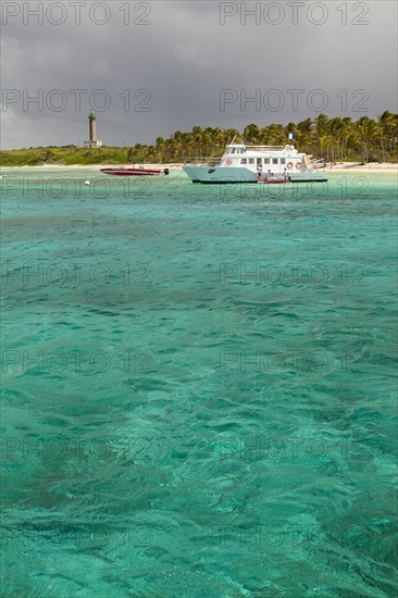 Boats off the island with a lighthouse