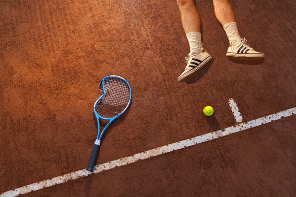 Tennis player lying on the ground