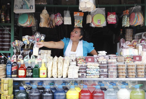 Woman selling sweets and drinks made from sugar cane