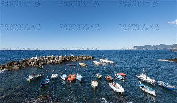 Boats in the harbor in front of harbour protection wall