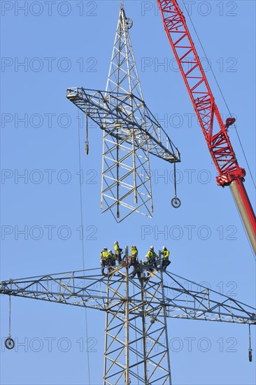 Overhead linemen working on a pylon