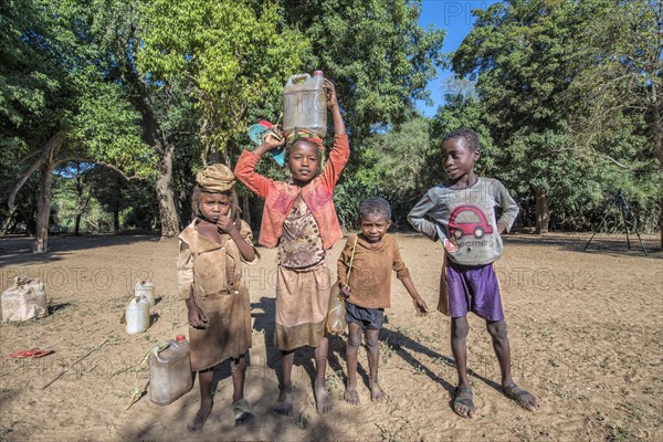 Children carrying water from the river