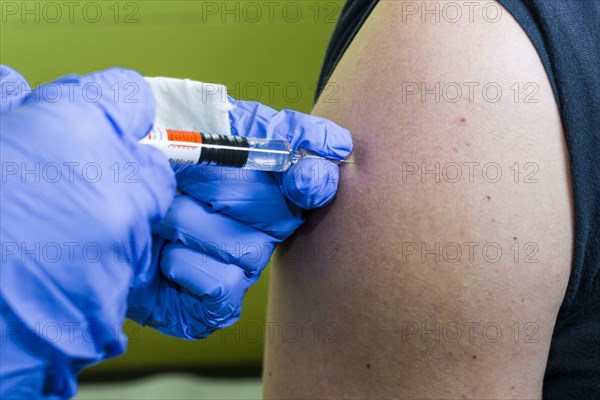 Injection of medicine into an arm