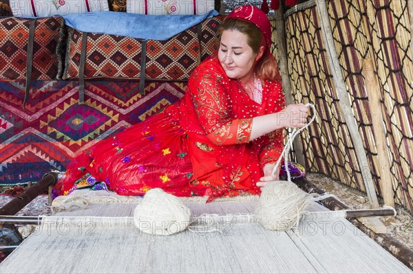 Qashqai woman weaving a carpet