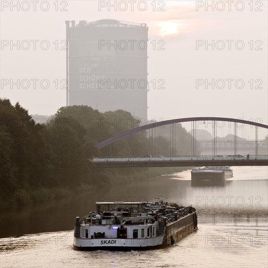 Two cargo ships on the Rhine-Herne Canal with Gasometer