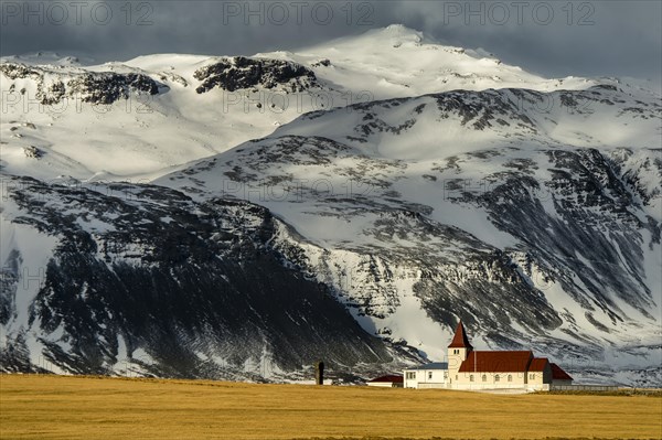 Small chapel in front of tall