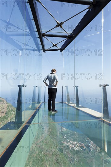 Woman taking in the view of the village of Agulo from the restaurant Mirador de Abrante