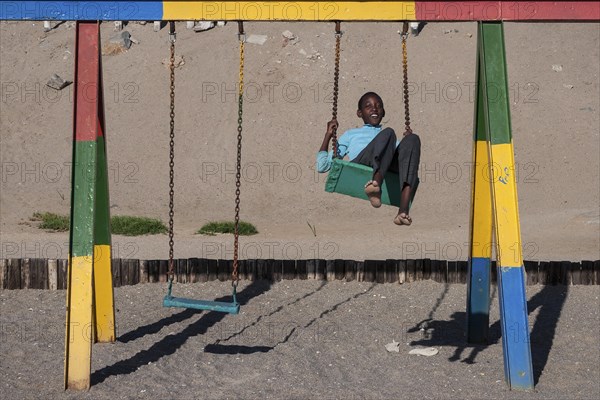 Local boy playing on a swing