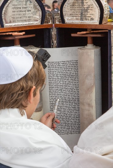 A young Jew reads from the Torah in Jerusalem